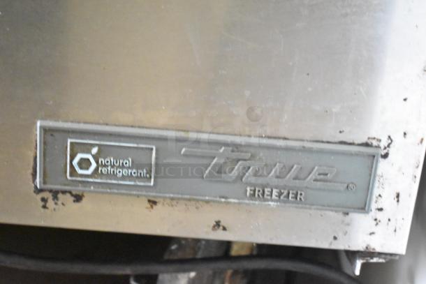 2017 True TWT-48F-HC commercial freezer label, showing "natural refrigerant" marking on stainless steel surface.