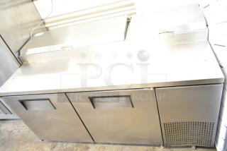 True TPP-67 commercial pizza prep table with stainless steel finish, two doors, and refrigeration unit on casters. 115V, 1 phase.