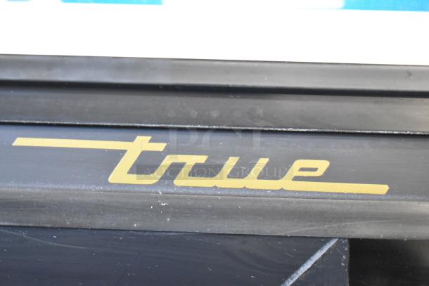 True GDM-45-LD cooler, "True" logo detail. Commercial 2-door, 115 volts, 1 phase, durable and efficient.