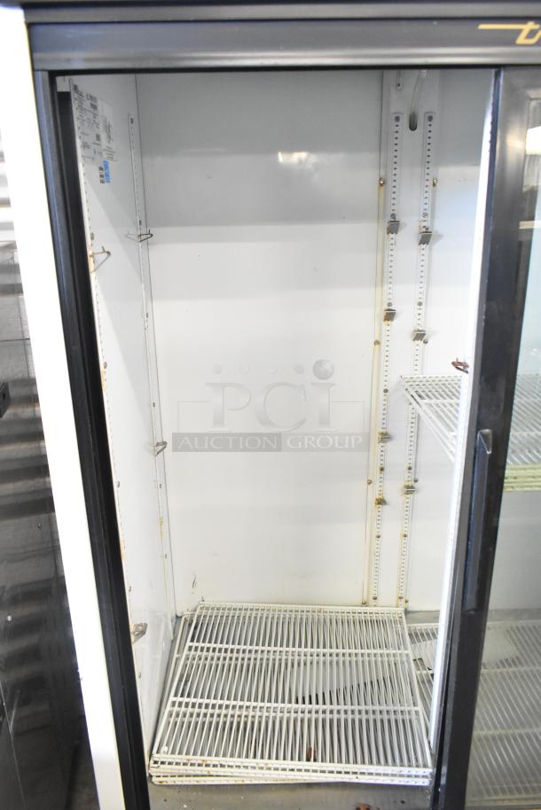 True GDM-45-LD commercial reach-in cooler merchandiser, 2 door, 115 volts, clean interior, minor wear, shelving visible.