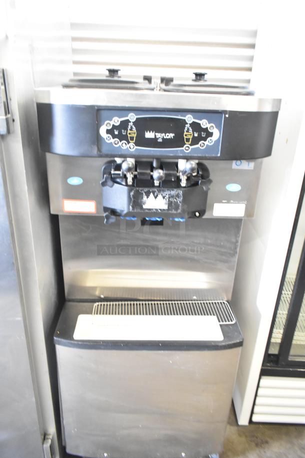 Taylor C712-33 commercial soft serve ice cream machine with two flavors and twist option on casters. Water-cooled, 208-230V, 3 phase.