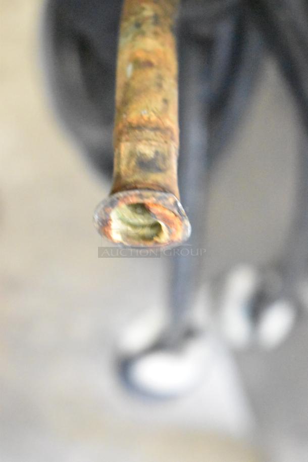 Close-up of a rusted pipe on a commercial ice cream machine, highlighting wear. Taylor model C712-33, water-cooled.