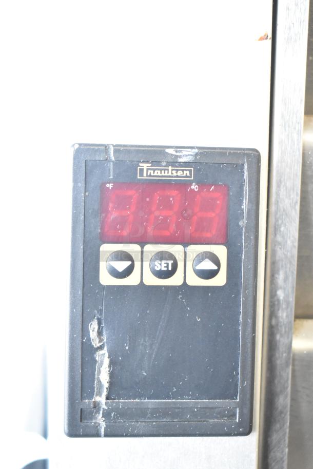 Traulsen G31010 commercial freezer display panel, shows digital settings. Visible wear indicates usage. Model detail seen.