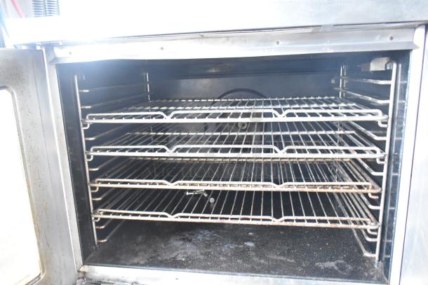 Blodgett commercial convection oven with view-through solid door and four wire racks, showing thermostatic controls, used condition.