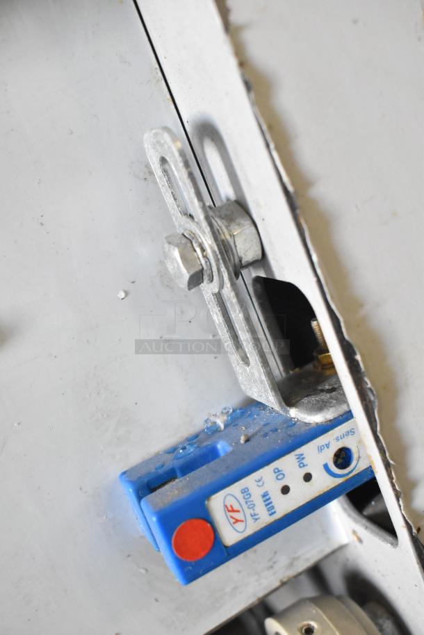 Leadway ET-99SU cup sealing machine, metal construction, shows mounting bolt and label with sensor details.