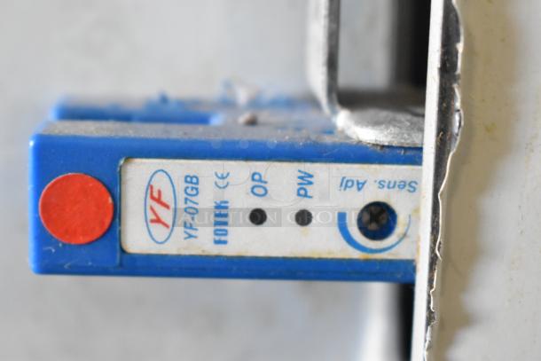 Close-up of YF-07GB Fotek sensor panel on Leadway ET-99SU cup sealing machine, showing controls and indicators.