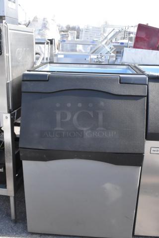 Stainless steel commercial ice bin with black top, good condition. Ideal for restaurant use, no visible dents or scratches.
