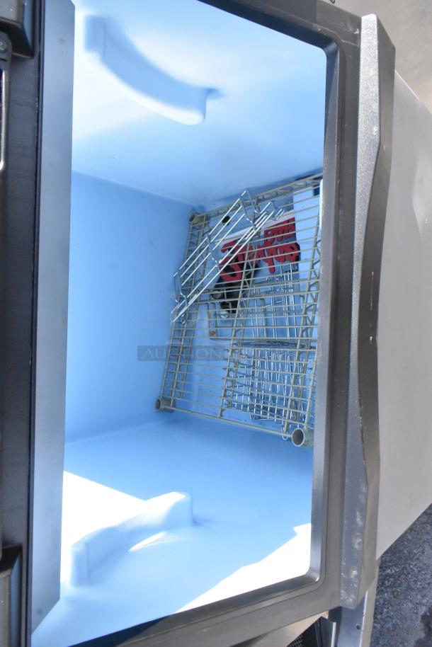 Commercial ice bin with stainless steel interior, removable rack, and insulated walls. Excellent condition, suitable for businesses.