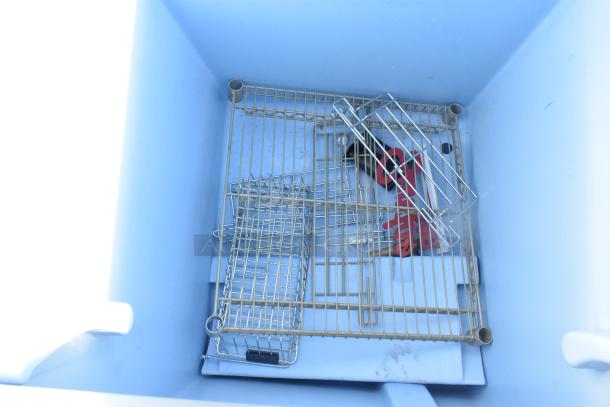 Commercial ice bin with metal racks, in good condition, features a spacious interior for ice storage, suitable for restaurants.