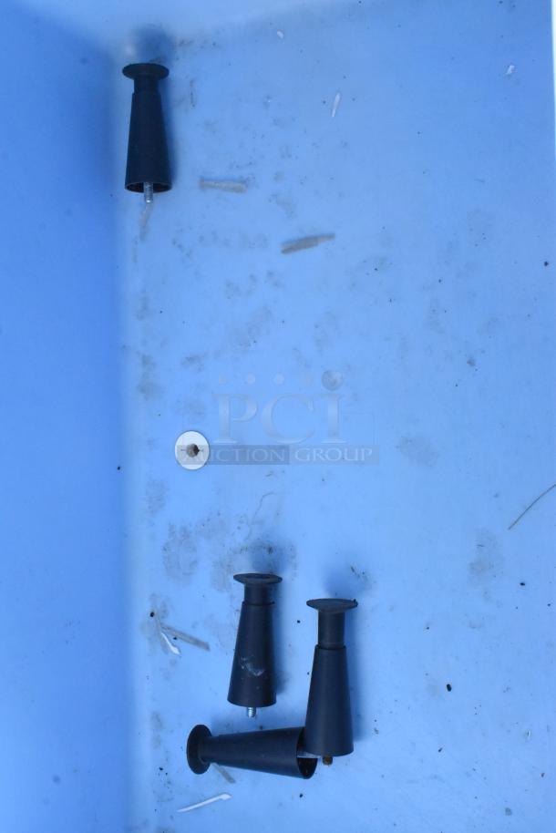 Ice-O-Matic Commercial Ice Bin interior showing black cone-shaped legs and scattered debris. Needs cleaning.