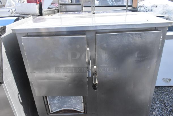Commercial 2-door undercounter cooler, stainless steel, 115 volts, 1 phase, some surface wear visible.