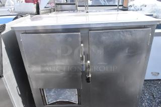 Commercial 2-door undercounter cooler, stainless steel, 115 volts, 1 phase, some surface wear visible.