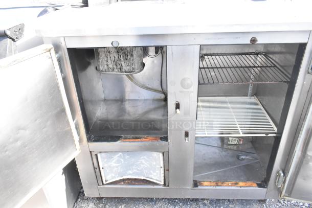 Commercial 2 Door Undercounter Cooler, 115 Volts, 1 Phase, stainless steel, open doors showing shelves, moderate wear.