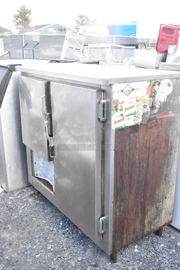 Commercial 2 Door Undercounter Cooler, stainless steel, 115V 1 Phase, visible rust and wear, exterior labels intact.