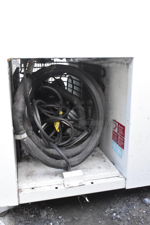 Master-Bilt DC-10D commercial chest freezer with visible compressor components. Includes commercial casters. Model label shown.