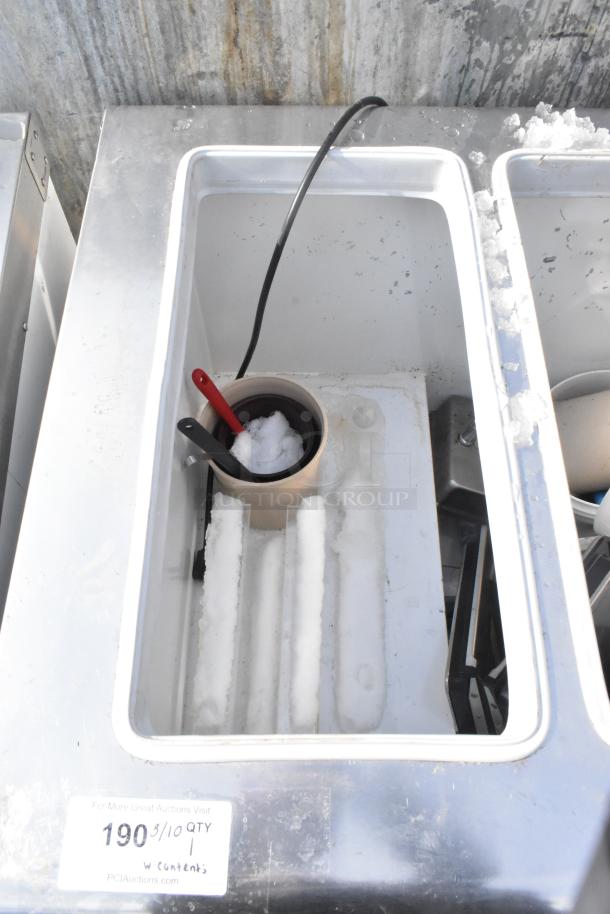 Kelvinator commercial chest freezer with casters, 208-230V, 1 phase. Inside has frost and ice build-up. Tag indicates quantity.