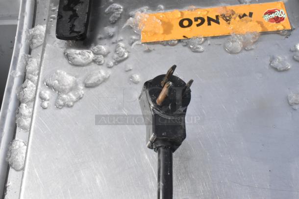 Kelvinator Commercial Chest Freezer top view with frost, handle, and power plug. Contains a mango label.