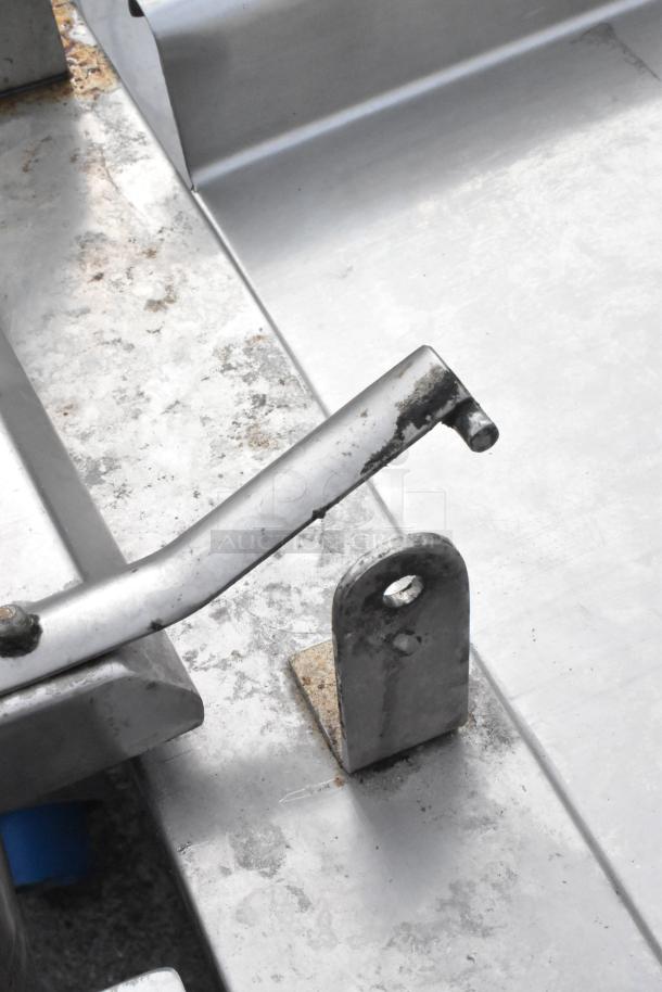 Groen FPC-3C braising pan detail; metal surface with visible wear, part of manual tilt mechanism shown.