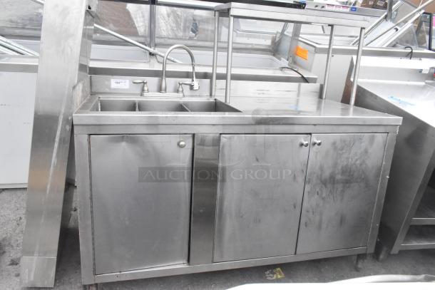 Commercial stainless steel 3 bay sink with over shelf and 3 doors. Includes faucet, visible wear, ideal for restaurant use.