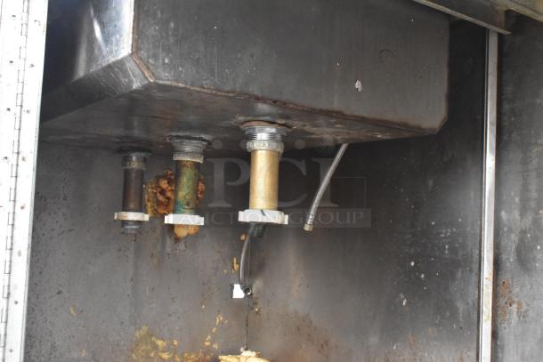 Commercial 3 Bay Sink underside, showing plumbing connections and signs of wear, suitable for commercial kitchen use.