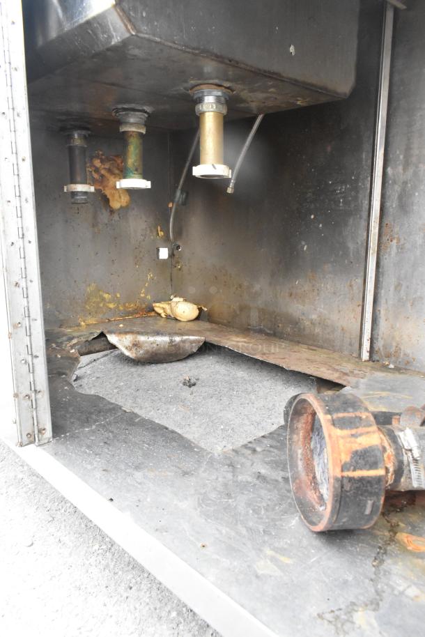 Commercial 3 bay sink with over shelf and 3 doors. Visible rust and wear, needs repair. Ideal for renovation projects.