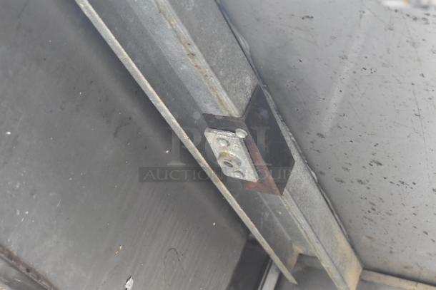 Alt text: Commercial 3 bay sink underside view, showcasing durable metal construction and a mounting bracket.