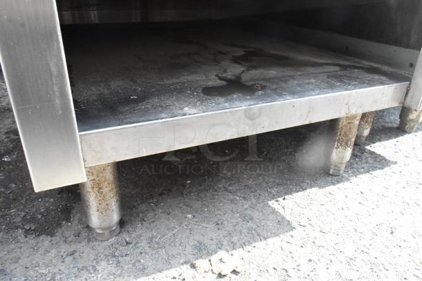 Commercial single bay sink with under shelf, stainless steel, moderate wear, visible rust on legs.