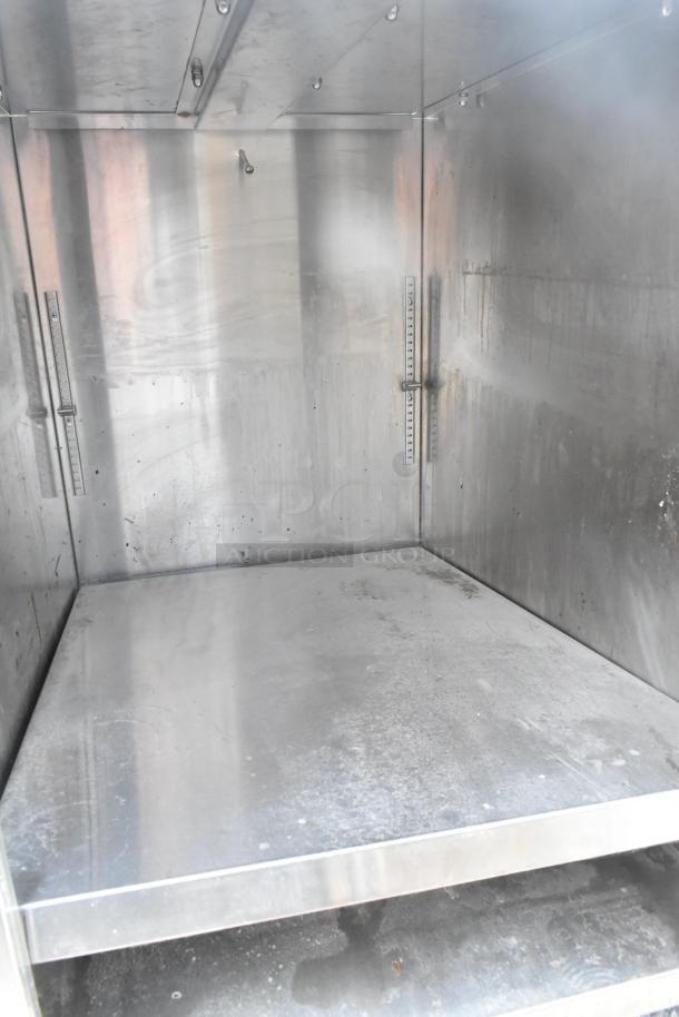 Commercial single bay sink with under shelf, stainless steel, some wear visible, ideal for restaurant use.