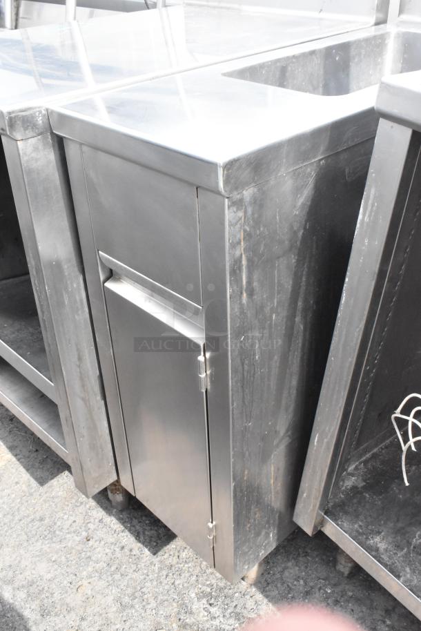 Commercial single bay sink with lower door, stainless steel, slightly worn, suitable for industrial kitchens.
