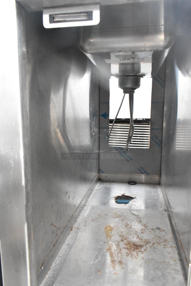 Commercial single bay sink with lower storage, stainless steel, visible rust and wear, plumbing connections included.