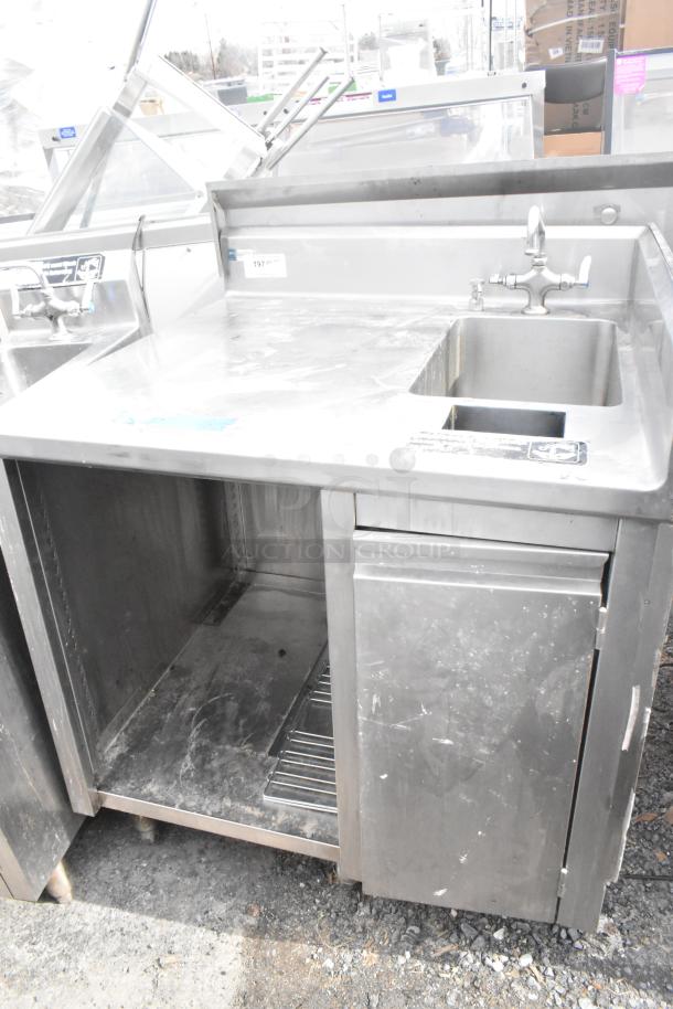 Stainless steel commercial single bay sink with under shelf, faucet, and drain. Visible scratches; used condition.