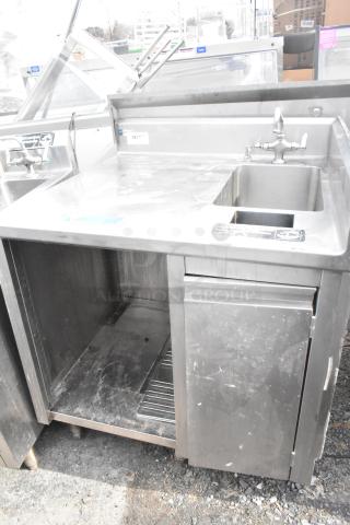 Stainless steel commercial single bay sink with under shelf, faucet, and drain. Visible scratches; used condition.