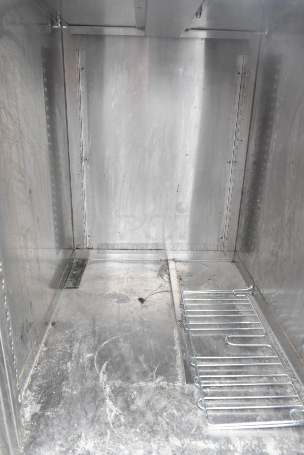 Commercial single bay sink with under shelf, stainless steel, used condition, visible wear and stains.
