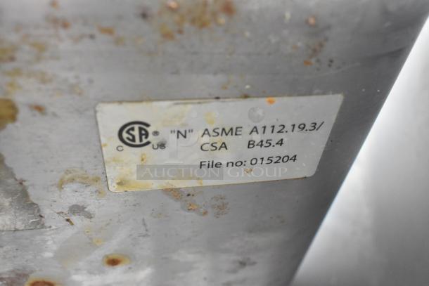 Label on commercial single bay sink indicates ASME A112.19.3 and CSA B45.4 standards; file number 015204.