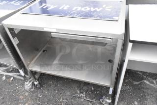 Commercial table with drawer and under shelf, on sturdy commercial casters, metal construction, good condition.