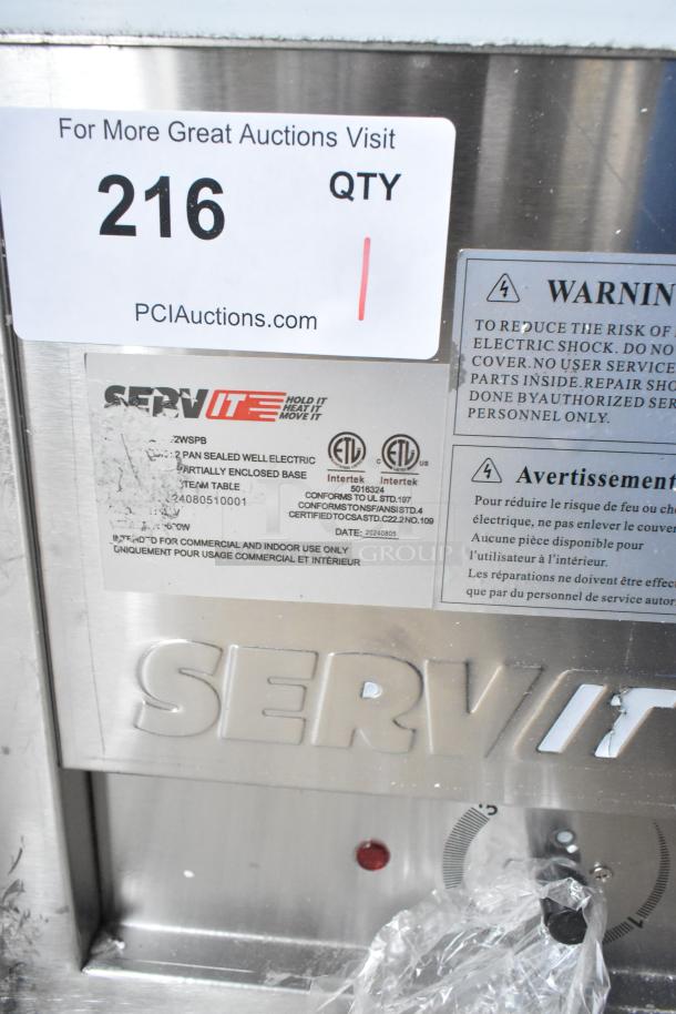 Brand new 2024 ServIt E-EST-2SW-CB electric steam table, two-pan, 120V, 1 phase, scratch and dent, with labels visible.