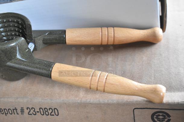 4 brand new K2811 Nut Master nutcrackers, scratch and dent, wooden handles, metal body, doubles as bottle opener.