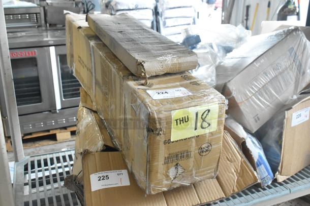 Cardboard boxes containing new items, including a 600SRS36S Regency 36" Speed Rail and 600LEGGALV12 Regency Leg for Sinks. Boxes marked for auction.