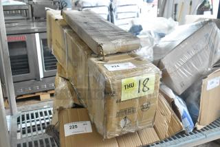 Cardboard boxes containing new items, including a 600SRS36S Regency 36" Speed Rail and 600LEGGALV12 Regency Leg for Sinks. Boxes marked for auction.