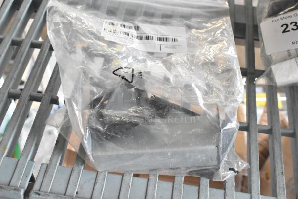 Package containing Embraco XC4XD0FK and OL1653 metal pieces. Items in plastic bag, barcode visible. Auction item.