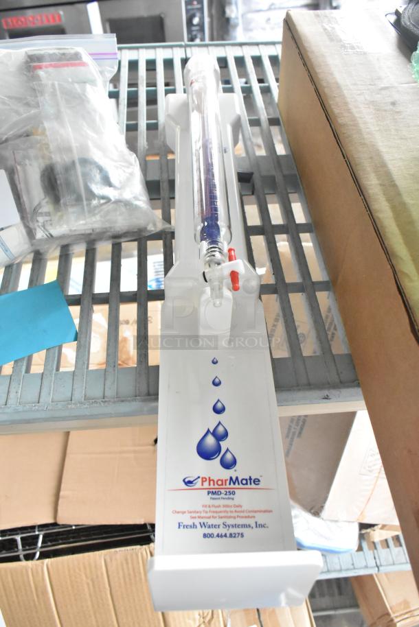 PharMate PMD-250 Dispenser on shelf, branded with Fresh Water Systems. Clear tube with red and white valve, in used condition.
