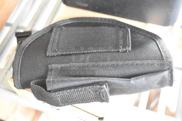 Black fabric pouch, secure Velcro flap, ideal for small electronics or accessories.