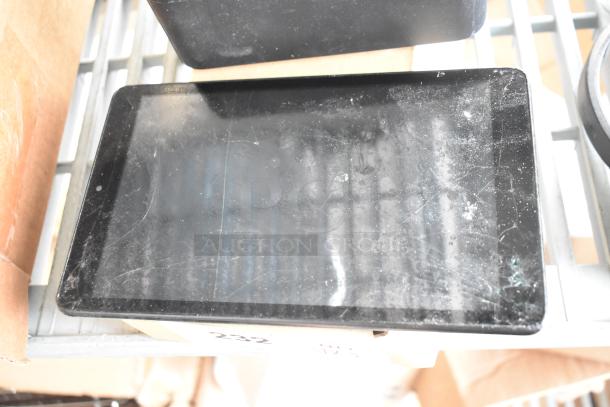 Tablet with visible scratches on screen, part of 5-item auction lot including an XG2v2-P and headphones.