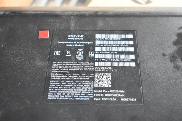 Label on XG2v2-P device showing brand, model, serial numbers, and FCC compliance. Made in Thailand, designed in Philadelphia.