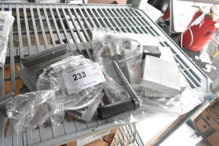 Nine assorted items including Accucold alarm, Robot Coupe blade, Bunn hose, and 2026 stickers, labeled "233 x9".