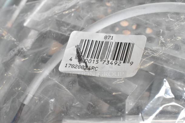 Assorted auction items including Accucold alarm, Robot Coupe food processor blade, and Bunn hose. Includes barcode 17828021RC.