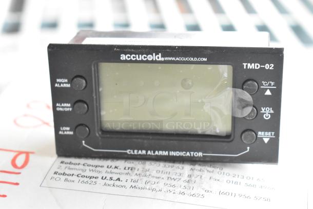 Accucold alarm model TMD-02 with high/low alarm buttons, Celsius/Fahrenheit toggle, and volume control.