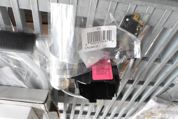 Various items including a food processor blade, hose, and labeled parts. Featuring tags: "17828011P" and barcodes.