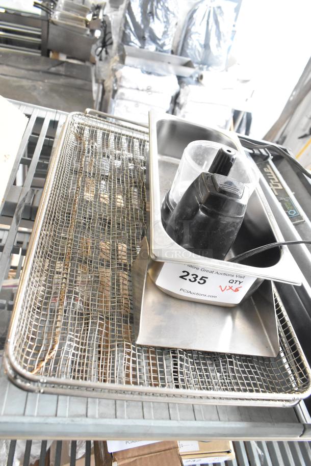 Five items on a shelf, including a True cooler kickplate, wire basket, and food processor without lid; auction tag visible.