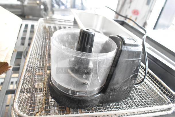 Five items including a food processor without a lid, wire basket, drop-in bin, and True cooler kickplate; worn condition.